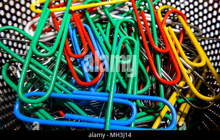 Colorful paper clip assortment close up with red, blue, yellow, and green Stock Photo