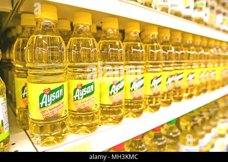 Holetown, Barbados, 03-19-2018: Bottles of Aysan sunflower oil stand on a shelf of a supermarket. Stock Photo