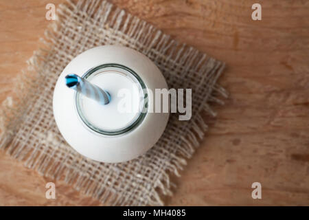 Bottle with milk on dark background with copy space. Top view. Stock Photo