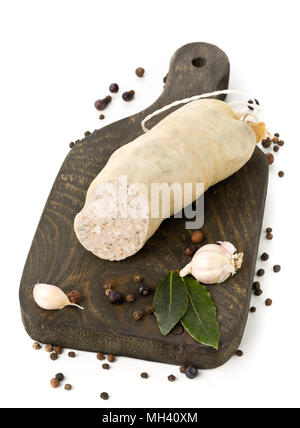 German specialty liverwurst (Leberwurst) with spices on wooden board over white background Stock Photo