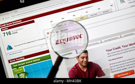 MONTREAL, CANADA - APRIL 10, 2018 : Equifax official site and logo under magnifying glass. Equifax Inc. is a consumer credit reporting agency. Stock Photo