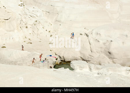 tourists at Sarakiniko beach on Milos island, Greece Stock Photo