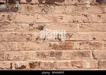 Background texture of brick wall with old chipped paint with some bricks showing through Stock Photo
