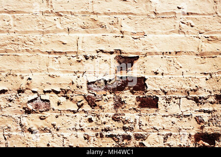 Background texture of brick wall with old chipped paint with some bricks showing through Stock Photo