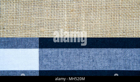 Sack color is brown and fabric color is black, white and gray texture background with copy space. Stock Photo