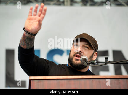 4-21-2018, SPRINT Pavilion, Charlottesville, VA, USA.  Former white supremacist and author Christian Picciolini speaking during Listen First in Charlottesville.  Listen First was part of the first National Week of Conversation (April 20-28, 2018).  Listen First’s weekend events in Charlottesville were created to support healing and reconciliation after 2017 white supremacist and pro-confederacy protests left one woman dead and a community divided.  A small number of seats of the 3,500 seat amphitheater were occupied on Saturday as speakers and panel discussions were presented. Stock Photo
