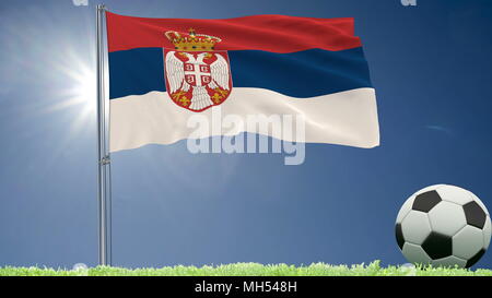 Flag of Serbia fluttering and a football rolls on the lawn, 3d rendering Stock Photo