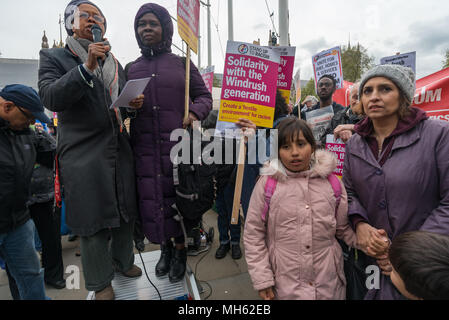 London, UK. 30th April 2018. Sara Callaway of Women of Colour in the Global Women's Strike (holding microphone) spekas at the protest in support of the petition calling for an end to the deportations of migrants in the 'Windrush generation' who arrived in Britain between 1948 and 1971. It calls on the government to change the burden of proof which means they are now required to prove their right to remain, and to provide compensation for any loss and hurt.. re for man Credit: Peter Marshall/Alamy Live News Stock Photo