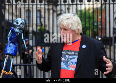 Westminster, London, 30th April 2018. 'Faux BoJo', a.k.a. Drew Galdron, performs as Foreign Secretary Boris Johnson opposite 10 Downing Street, singing with a puppet of Theresa May. Anti-Brexit and pro-European protesters gather outside and opposite 10 Downing Street for the 'Vigil against Brexit', while the House of Lords again debates the European Union (Withdrawal) Bill.
