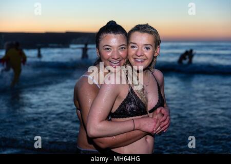 Scotland, UK. 1st May, 2018. Students at St Andrew's University take part in the tradition of the May Day Dip. Running into the North Sea at the East Sands at dawn is said to help improve performance in the upcoming Final Exams. Credit: Rich Dyson/Alamy Live News Stock Photo