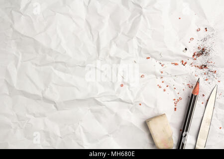 Put a pencil on white crumpled paper list  texture or background. Stock Photo