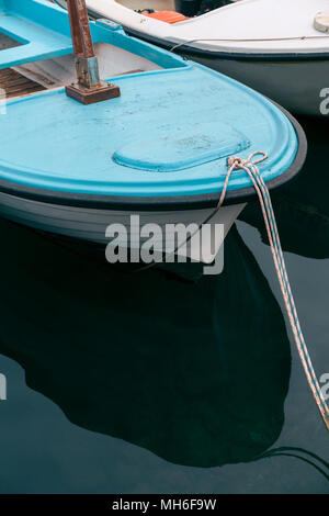 Small empty fisherman boat on the blue Adriatic Sea waters in Budva in Montenegro Stock Photo