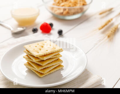 crackers with condensed milk and fruit, breakfast Stock Photo