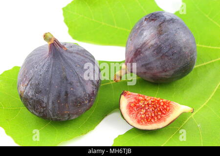 composition of fresh fig fruits on a fig leaf Stock Photo