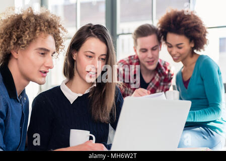 Two young students searching for an answer to their question Stock Photo