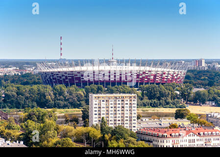 Warsaw / Poland - 09.15.2015: Aerial view on the modern architecture national football stadium with tall house building in front. Stock Photo