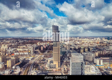 Warsaw / Poland - 03.16.2017: Panoramic view at the tallest modern skyscraper in the town district with dramatic, dark clouds. Stock Photo