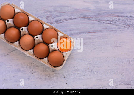 Overhead view of chicken eggs in an open egg carton isolated on white. Fresh chicken eggs background. Top view with copy space. Natural healthy food a Stock Photo