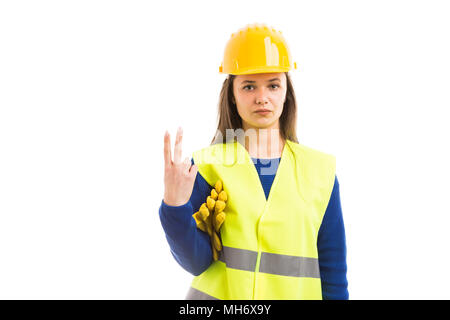 Young attractive female architect or engineer showing number two with fingers as building contractor sign isolated on white background Stock Photo