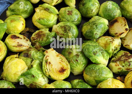 pan-fried brussels sprouts in an iron pan in closeup view Stock Photo