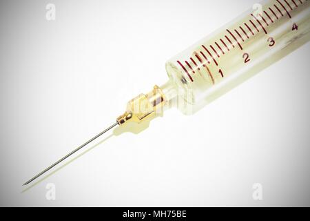 medical syringe made of glass on vintage background with a needle for injections Stock Photo