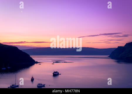 Boat on the water during dusk just before sunrise with the moon and blue and orange color Stock Photo