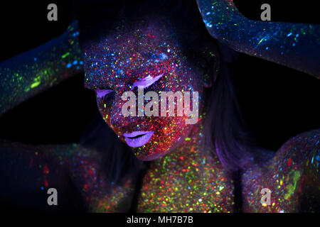 Portrait of Beautiful Fashion Woman in Neon UF Light. Model Girl with Fluorescent Creative Psychedelic MakeUp, Art Design of Female Disco Dancer Model in UV Stock Photo