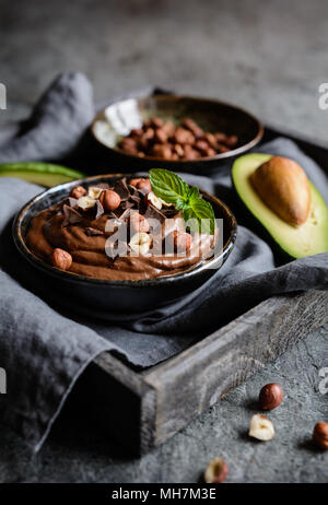 Raw avocado chocolate mousse topped with hazelnuts Stock Photo