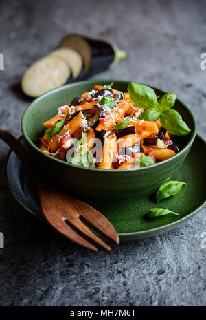 Pasta alla Norma - traditional Italian food with eggplant, tomato, cheese and basil Stock Photo