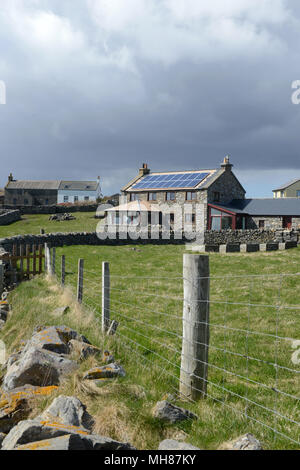 Houses an shoreline around Gletness a village on the east side of Shetland. House also with solar panels for electricity Stock Photo