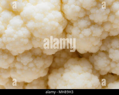 Close up shot of raw white cauliflower organic texture in abstract form look like snow mountain or hill used as background with concepts of cooking, healthy, wellness, organic, diet, and ingredient Stock Photo