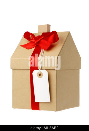 House wrapped in brown paper with red gift ribbon and white address label isolated on white background Stock Photo