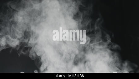 vapor steam rising over black background Stock Photo