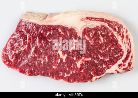 Ripened seasoned beef rump or striploin steak on white background isolated. Yop view. Stock Photo