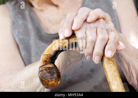 Old woman hands with cane Stock Photo