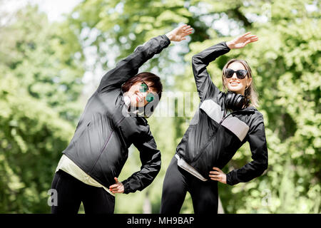 Two woman exercising in the park Stock Photo