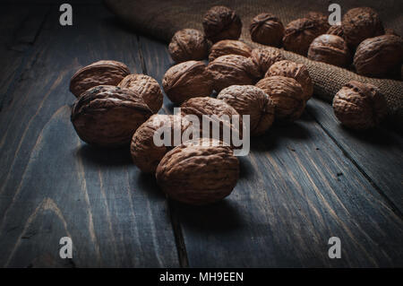 Almonds, walnuts and hazelnuts on wooden table. assortment of nuts Stock Photo