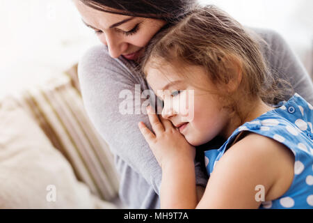 Young mother with a small girl at home. Stock Photo