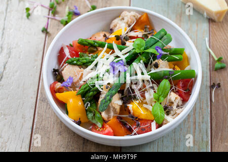 Italian panzanella bread and tomato salad with roast peppers, asparagus, parmesan and micro greens Stock Photo