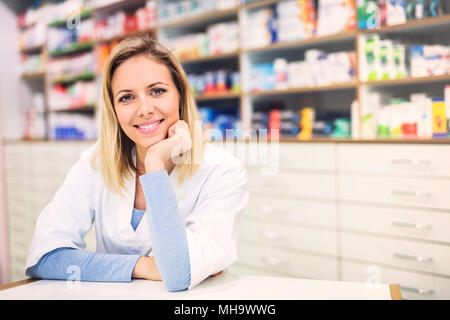 Portrait of a young friendly female pharmacist. Stock Photo
