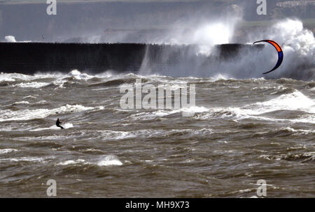 A kite surfer braves the rough seas in Tynemouth, Northumberland. Stock Photo
