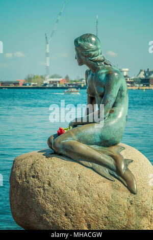 COPENHAGEN, DENMARK - APRIL 28, 2018: Iconic bronze mermaid sculpture, by Edvard Eriksen, of a character from H.C. Andersen's fairytale. Stock Photo