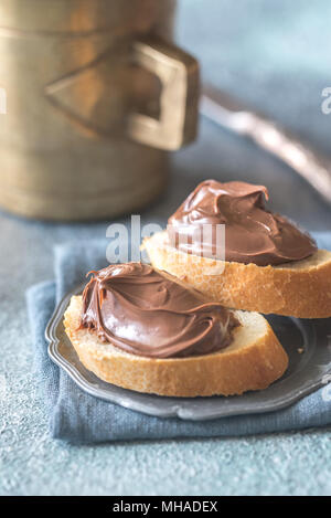 Slices of baguette with chocolate cream on the saucer Stock Photo