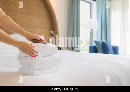 Hands of hotel maid  bringing fresh towels to the room Stock Photo