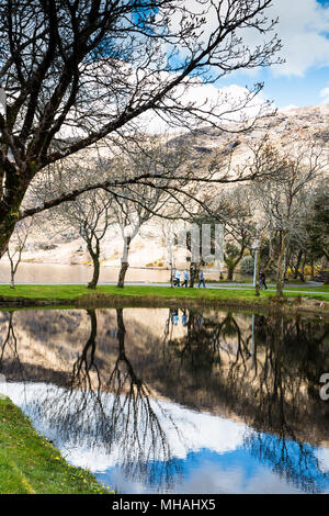 April 30th, 2018, Gougane Barra, Ireland - people walking towards Saint Finbarr's Oratory, a chapel built on an island in Gougane Barra, a very serene Stock Photo