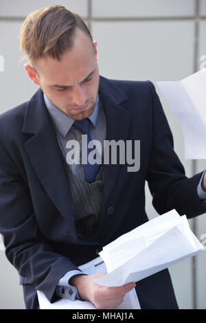 businessman emotionally reading documents Stock Photo
