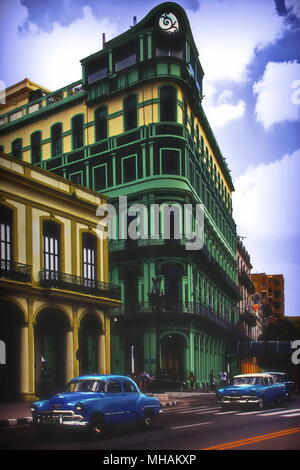 Vintage Cars on Havana street in front of colorful buildings, Cuba Stock Photo