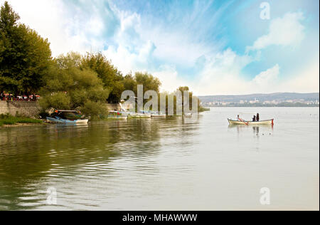 Beautiful reflection on sea and a boat which is built with wooden pieces Stock Photo