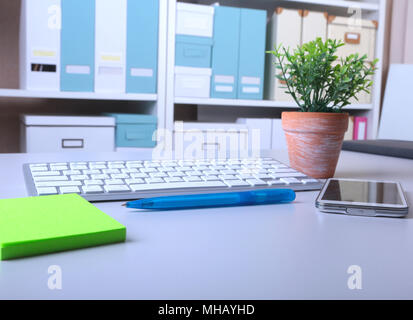 Office desk with keyboard and stikers, papers Stock Photo