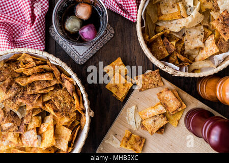 Homemade Crispy Chips / Snacks in a wooden bowl. (fun concept) Stock Photo